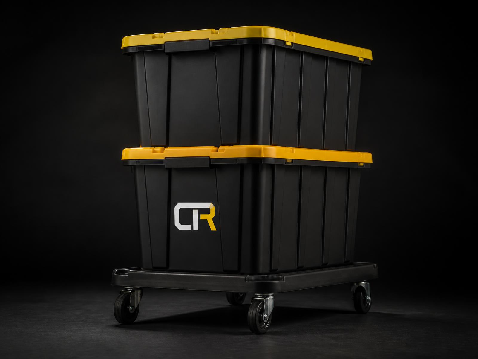 Two CTR-branded black moving totes with yellow lids stacked on a low black four-wheel Tote Taxi